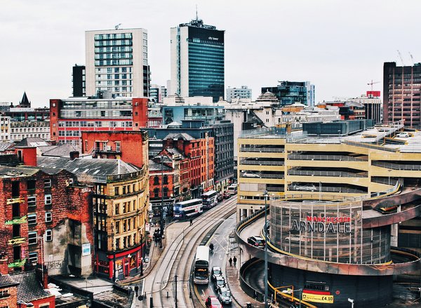 How can you explore the history of the Industrial Revolution in Manchester through interactive exhibits?